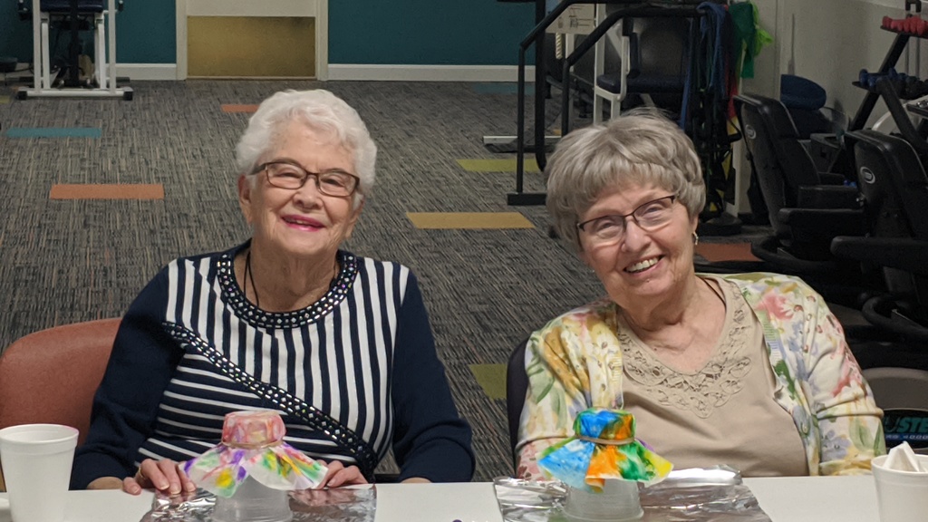 two senior citizens making an art project